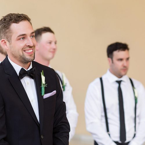 Groom watching bride walk down aisle at NOW Jade Cancun