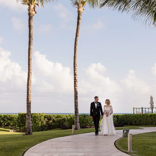 Bride and groom walking on path after their wedding at NOW Jade Cancun