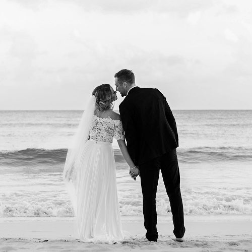 Bride and groom kissing on beach in Cancun