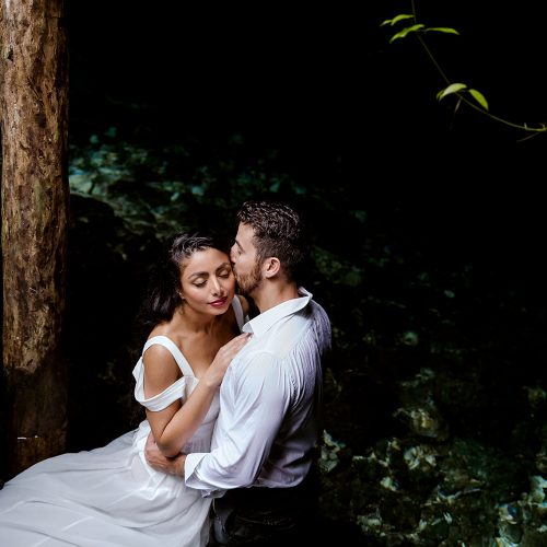Bride and groom in water at trash the dress in Mexico