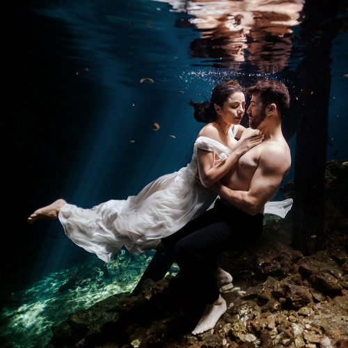 Bride and groom in underwater TTD with shirt off
