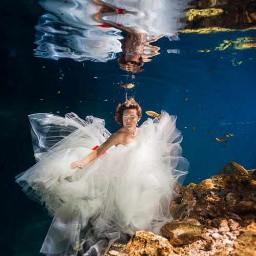 Bride underwater in Trash the Dress shoot in Mexco