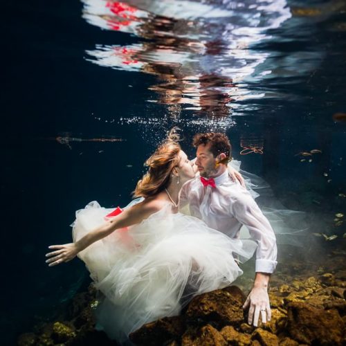 Bride and Groom underwater in Cenote, riviera maya mexico