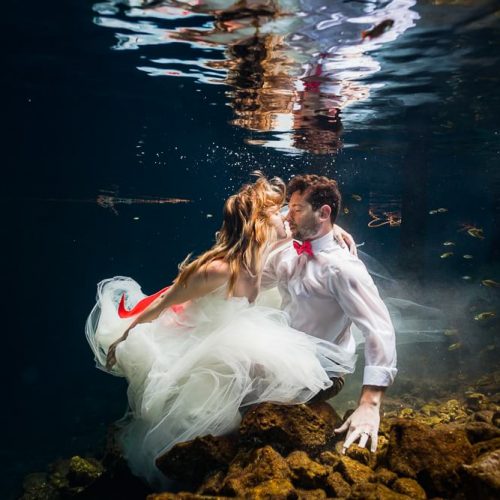 Bride and Groom underwater in wedding closes in Cenote, Riviera Maya Mexico