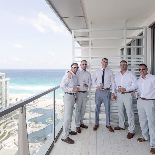Groomsmen on balcony at Secrets on the vine Cancun