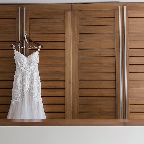 Brides wedding dress hanging in room at Secrets on the vine Cancun