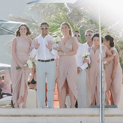 Wedding party arriving at ceremony on beach.