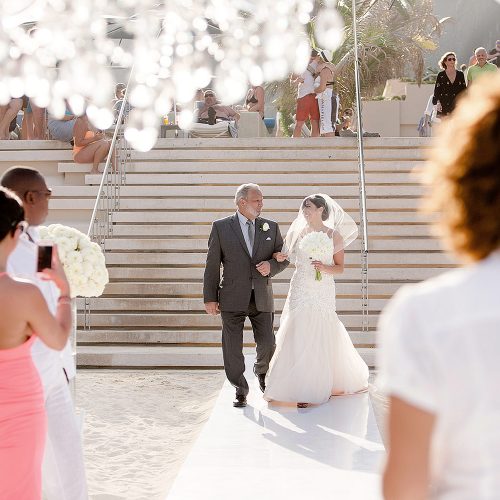 Bride walking down aisle at Secrets on the vine Cancun beach wedding ceremony