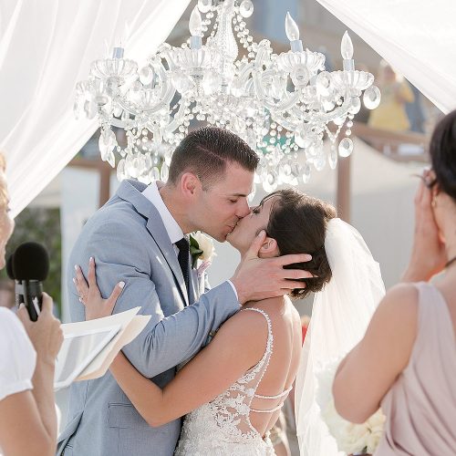 Bride and grooms first kiss at wedding ceremony