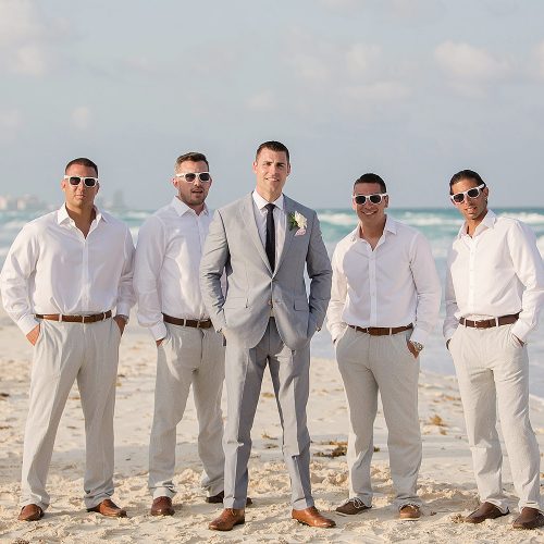 Groom and groomsmen on beach in Cancun