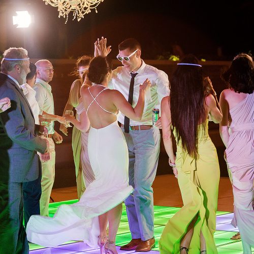 Bride and groom dancing with guests at wedding reception at Secrets on the vine Cancun