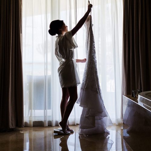 Bride holding up wedding dress at Moon Palace Cancun
