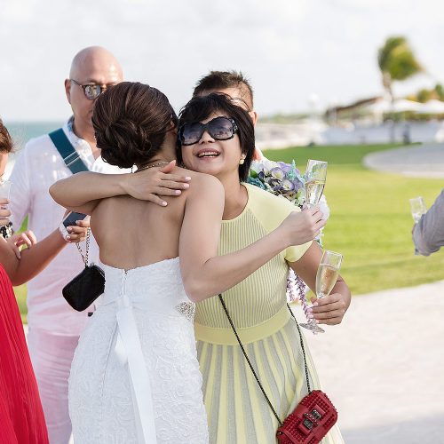 Guest hugging bride at Moon Palace Cancun wedding