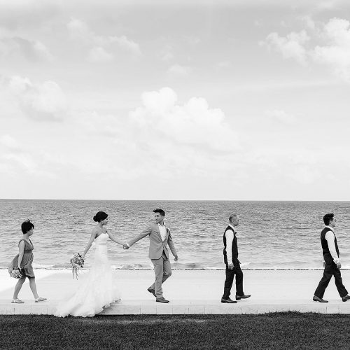 Bridal party walking near beach at Moon Palace Cancun wedding