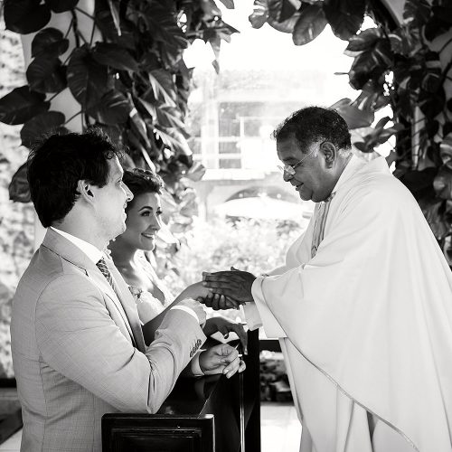 Bride and groom receiving mass at wedding ceremony