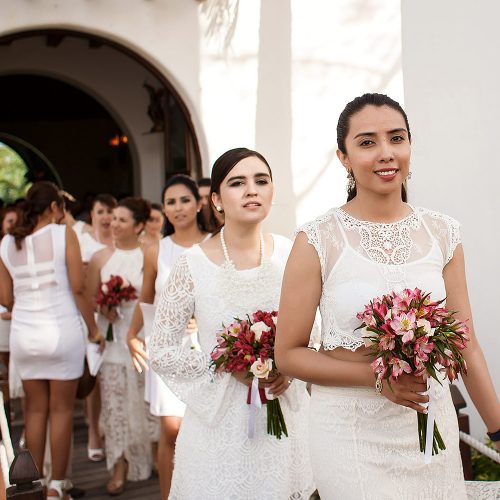 Bridal party walking out of church in Riviera Maya