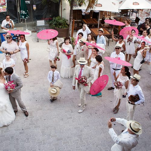 Bride and groom with mariachi band on streets in Riviera Maya