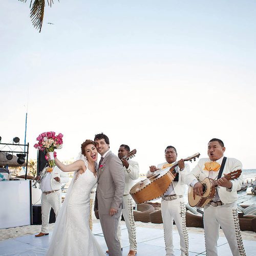 Bride and groom on dance floor with mariachi band in Riviera Maya