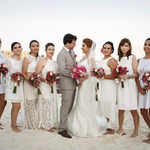 Bride and groom with bridal party on beach in Riviera Maya