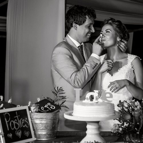 Groom feeding cake to bride at wedding