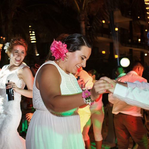 Guests dancing on dance floor at wedding