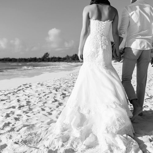 Bride and groom walking on beach in Riveira Maya Mexico