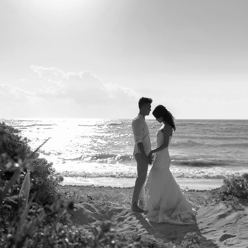 Bride and groom with Mexican Caribbean behind them.