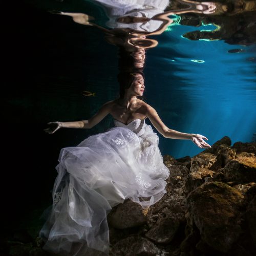 Asian bride underwater in Cenote Trash the Dress (TTD) in Mexico