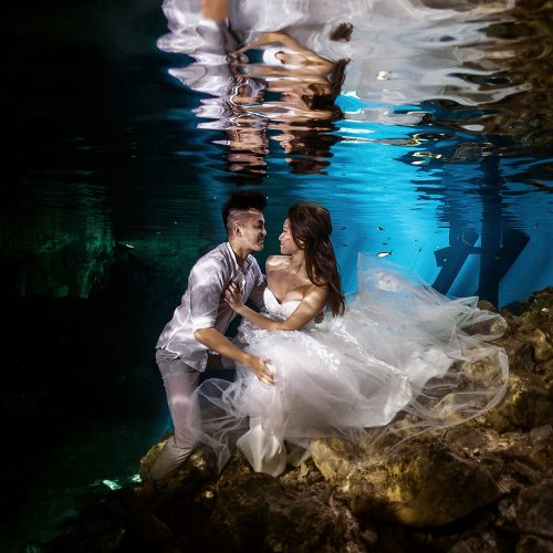 Bride and groom underwater in Cenote Trash the Dress (TTD) in Mexico
