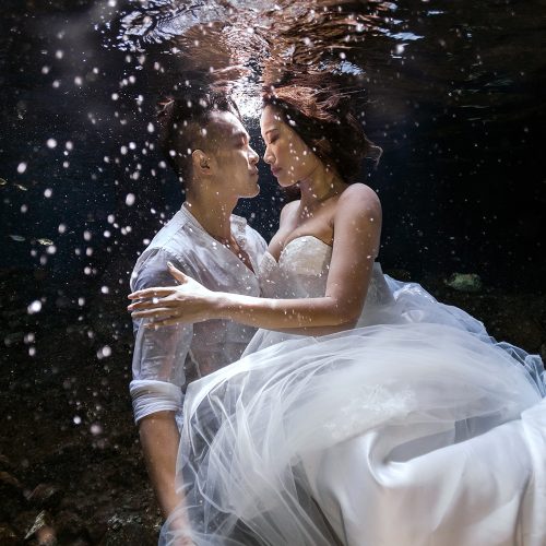 Bride and groom underwater in Cenote Trash the Dress (TTD) in Mexico
