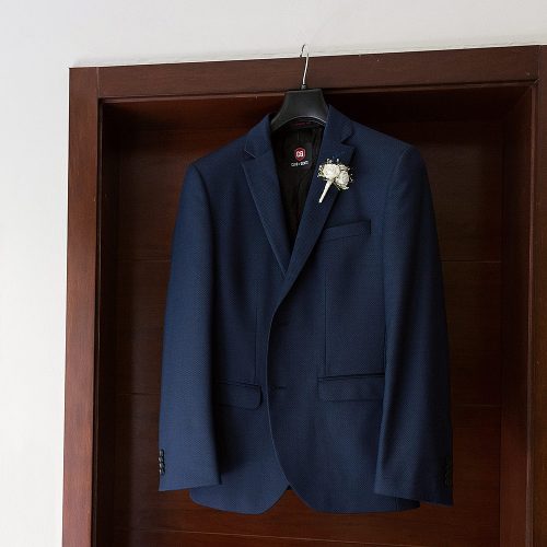 Groom jacket hanging on door