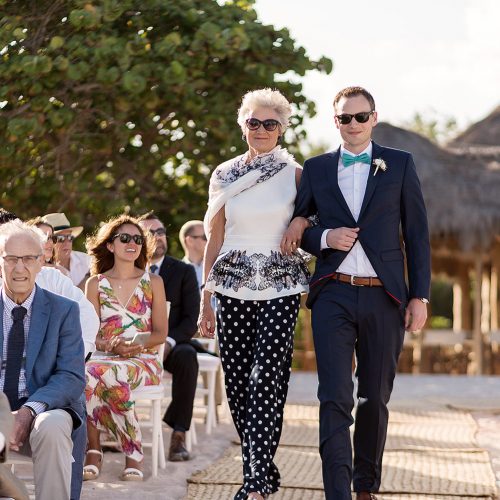 Groom walking down aisle with mother at Punta Venado, Riviera Maya Mexico