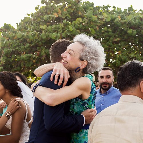 Groom and mother hugging after wedding ceremony