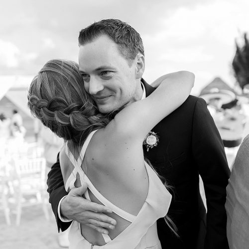 Groom hugging guest after wedding ceremony