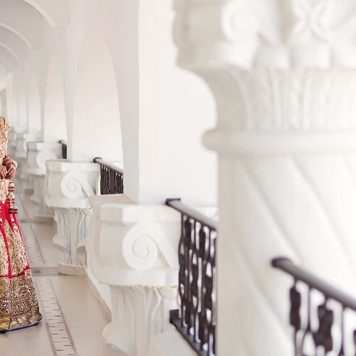 Indian bride walking in hallway before wedding in Cancun
