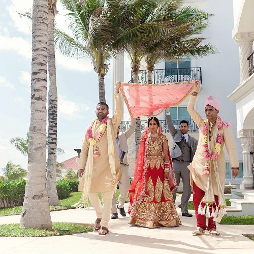 Indian bride being brought to the wedding ceremony in Cancun