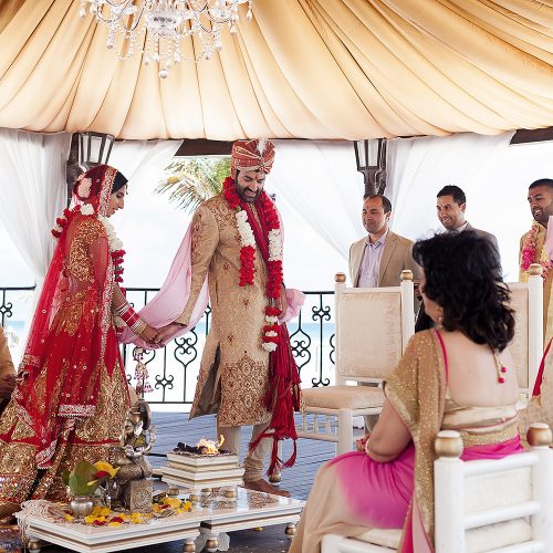 Bride following groom in Indian wedding ceremony
