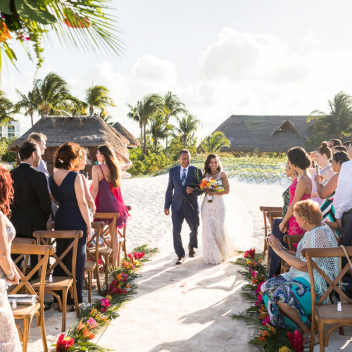 Bride walking down aisle at beach wedding at Finest Playa Mujeres