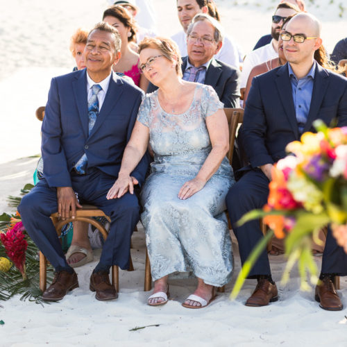 Guests at beach wedding ceremony.