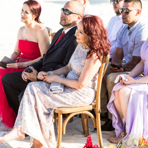 Guests at beach wedding ceremony.