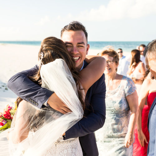 Bride hugging guest after wedding.