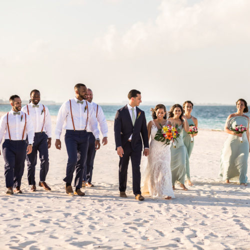Bridal party walking on beach at Finest Playa Mujeres