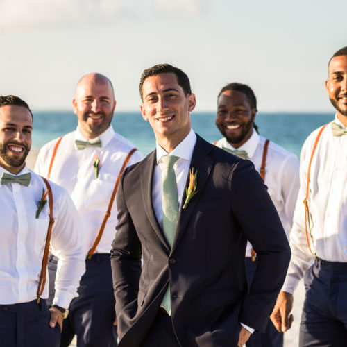 Groom and groomsmen on beach at Finest Playa Mujeres