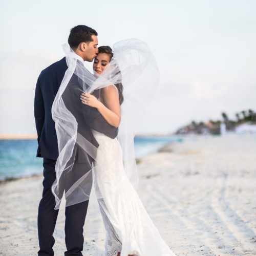 Bride and groom on beach at Finest Playa Mujeres