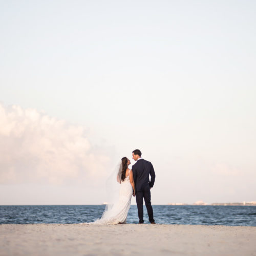 Bride and groom looking at ocean at Finest Playa Mujeres