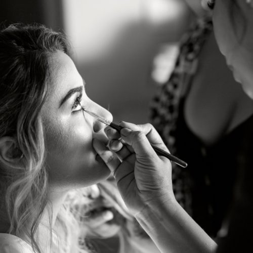 Close up of bride getting makeup put on.