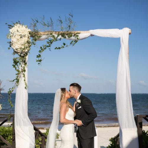 Bride and grooms first kiss at ceremony on tequila terrace at NOW Sapphire Riviera Maya Resort