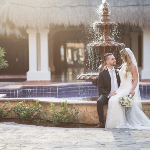 Bride and groom in front of fountain at NOW Sapphire Riviera Maya Resort