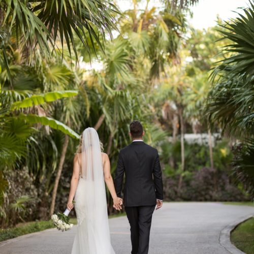 Bride and groom walking in garden at NOW Sapphire Riviera Maya Resort