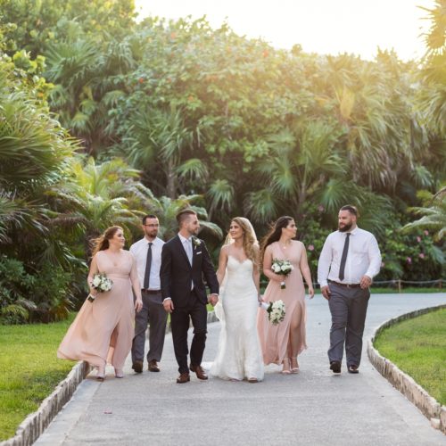 Bridal party walking on path in gardens at Bride in gardens at NOW Sapphire Riviera Maya Resort
